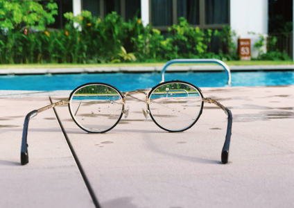Clarity brings peace of mind. Just as eyeglasses bring the world into sharp focus, we make our storage agreements clear and simple. The calm pool in the background represents the confidence you feel when you understand all the details. This image is our promise of transparency for our terms and conditions.